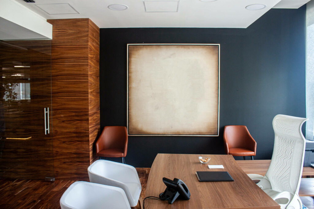 Modern office wallpaper with wood paneling navy accent wall sleek desk and orange chairs