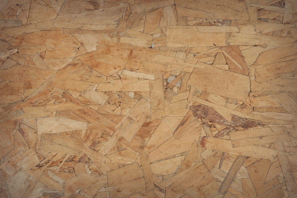 Natural oriented strand board wallpaper with rustic textured wood strands background