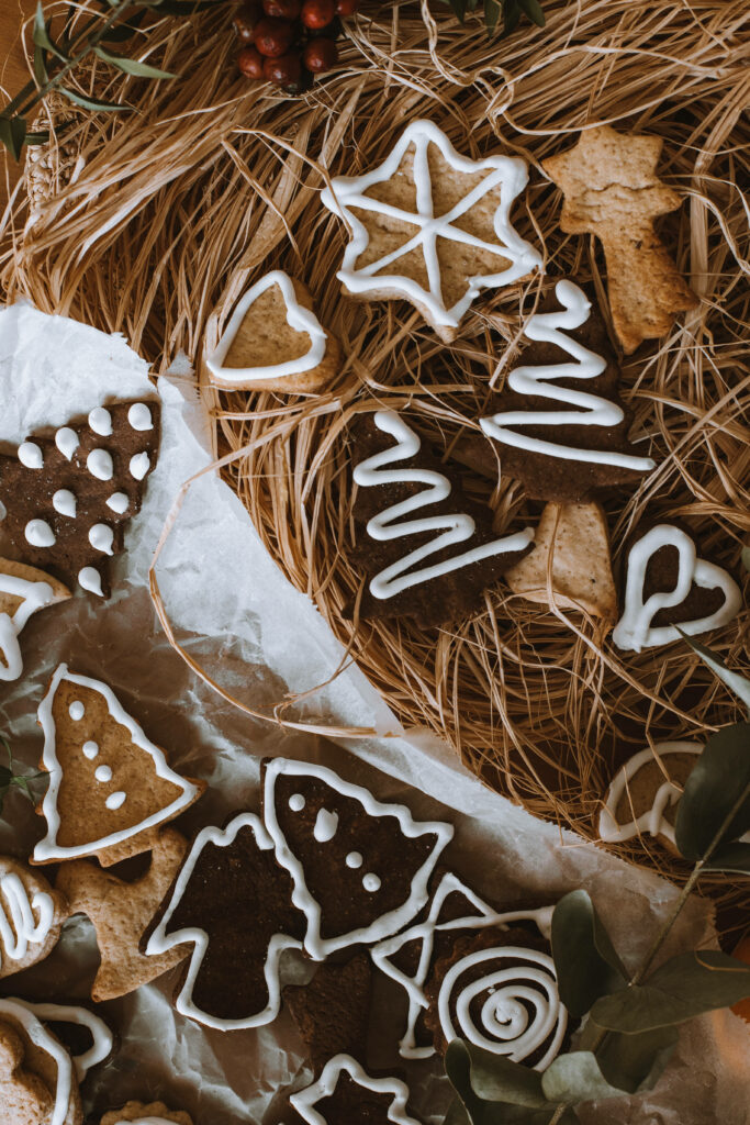 Rustic Christmas Cookies Background: Festive Star, Tree, and Heart Designs Wallpaper