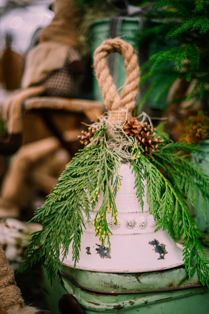 Rustic Christmas Wallpaper: Decorative Bell with Pine & Cones Background