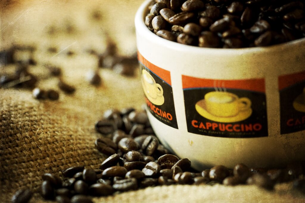 Rustic Wallpaper: Cappuccino Cup & Coffee Beans on Burlap Backdrop