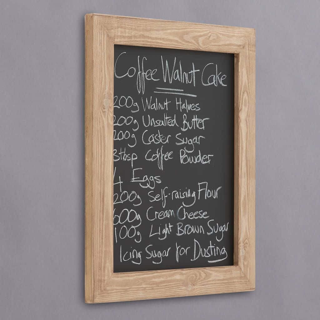 Rustic blackboard with handwritten Coffee Walnut Cake recipe in white chalk on wood frame Wallpaper