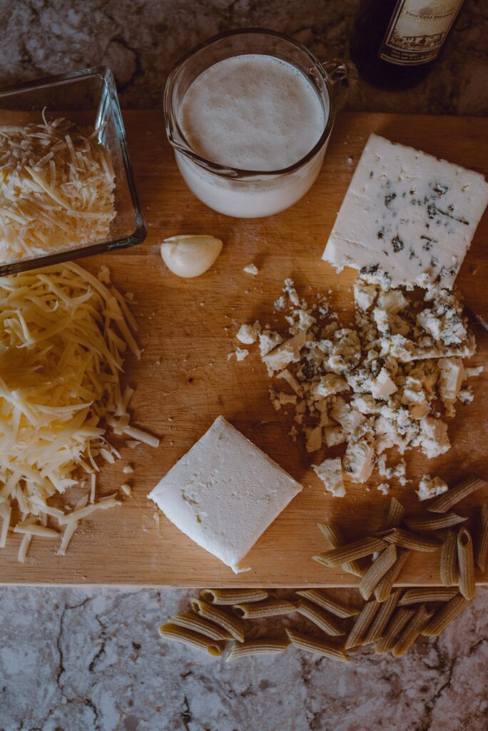 Rustic Cooking Wallpaper: Cheese, Pasta & Garlic on Wooden Surface