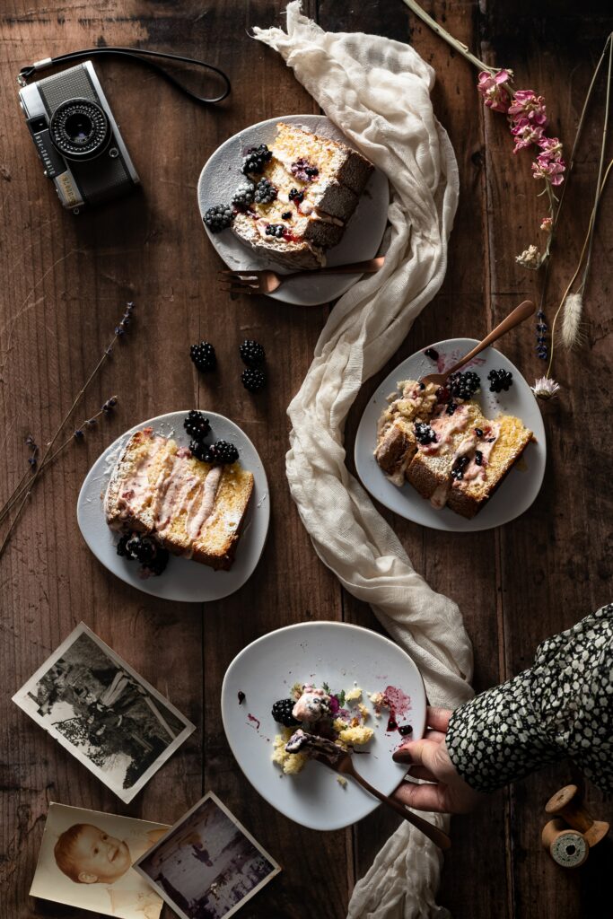 Rustic Dessert Setup: Berry-Topped Cakes & Vintage Decor on Wood Wallpaper
