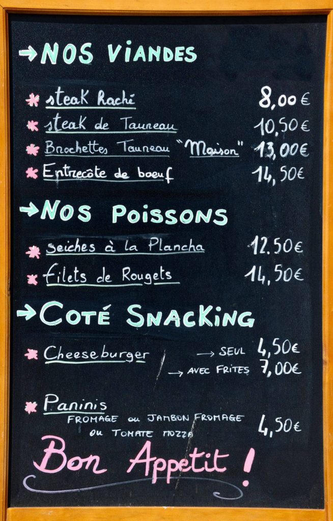 Rustic chalkboard menu wallpaper with vibrant French text featuring meat fish snacks and Bon Appétit