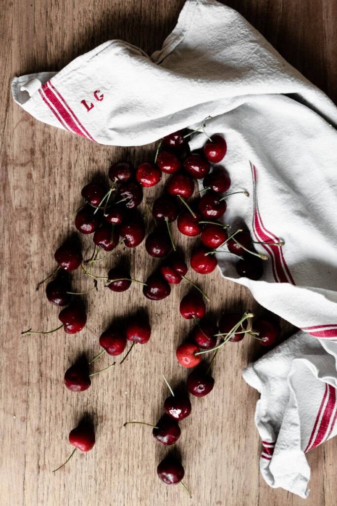 Rustic Cherry Arrangement on Wood: Inviting Wallpaper Background