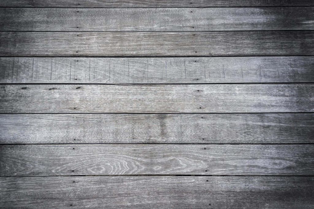 Rustic gray wood plank background with weathered timber texture and moody vignette edges Wallpaper
