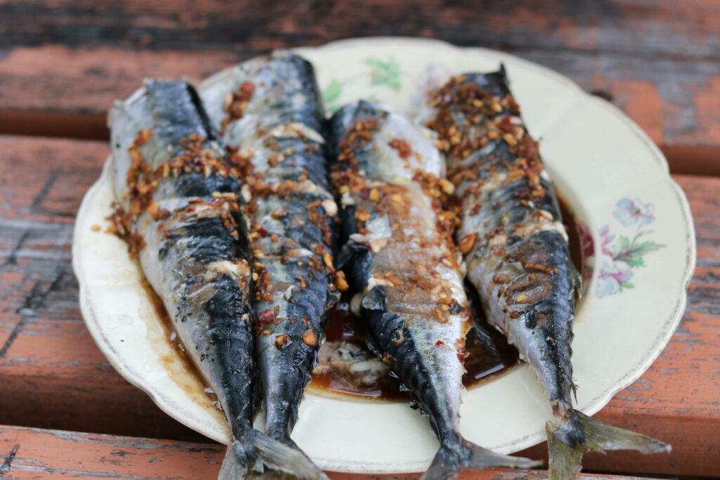 Rustic Grilled Herrings: Spiced Seafood Delight Wallpaper Background