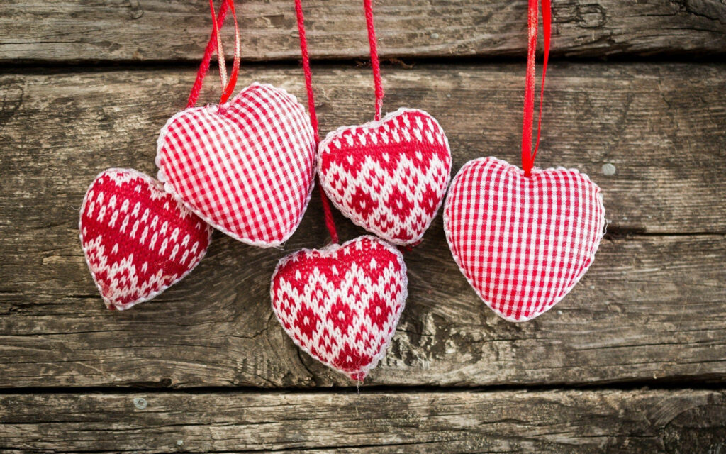 Rustic Heart-Shaped Decorations Wallpaper on Weathered Wood