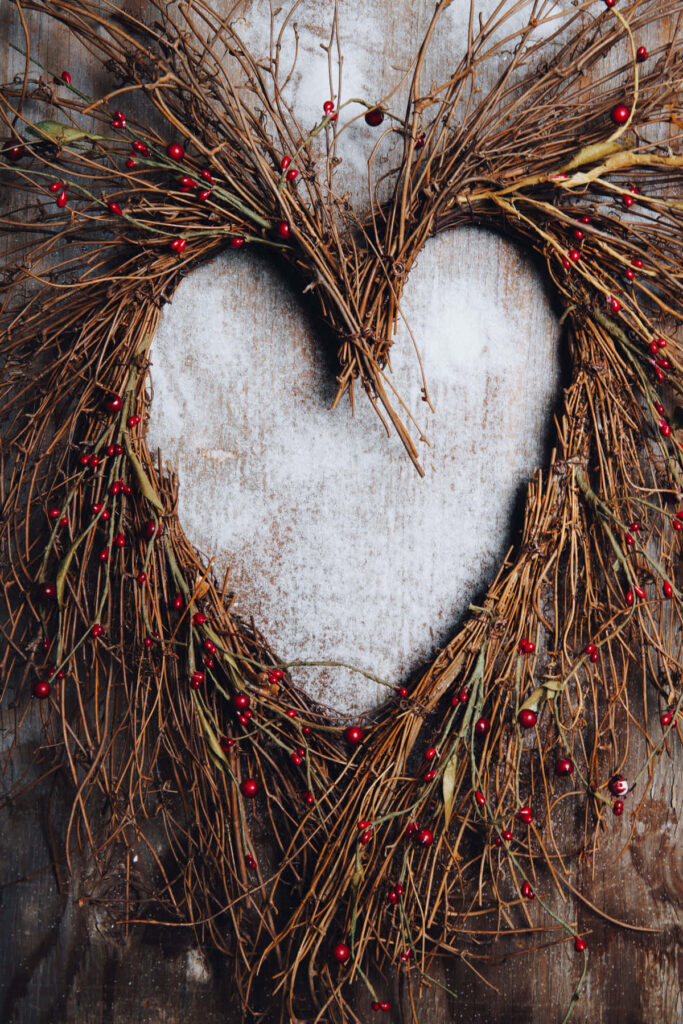 Rustic Heart-Shaped Wreath with Red Berries on Wooden Wallpaper