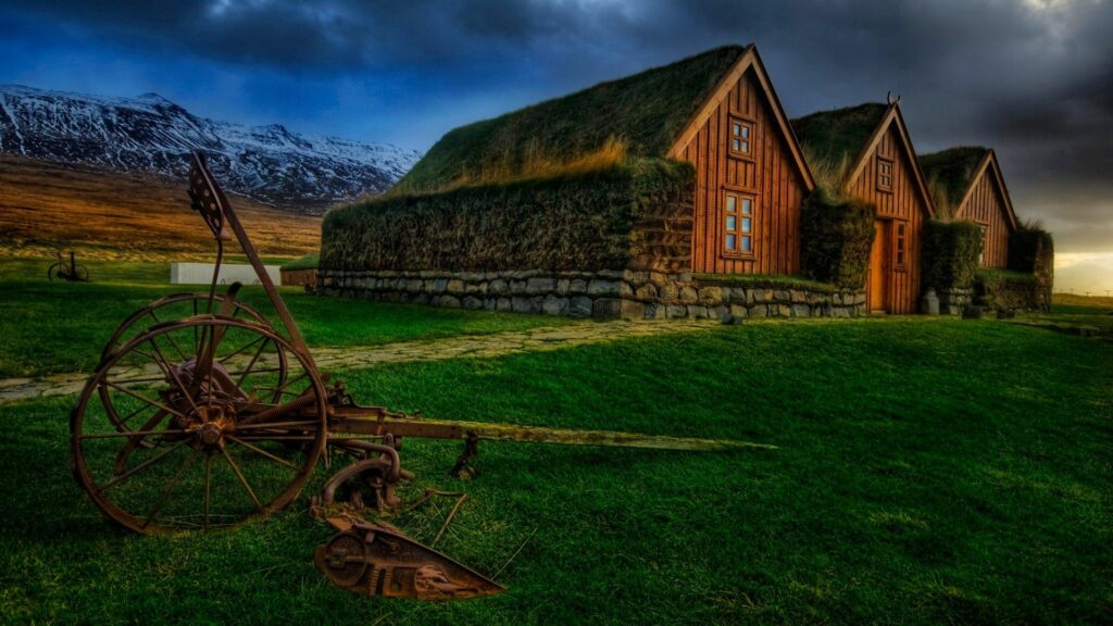 Rustic Homes Amid Snowy Mountains - Serene Wallpaper Background