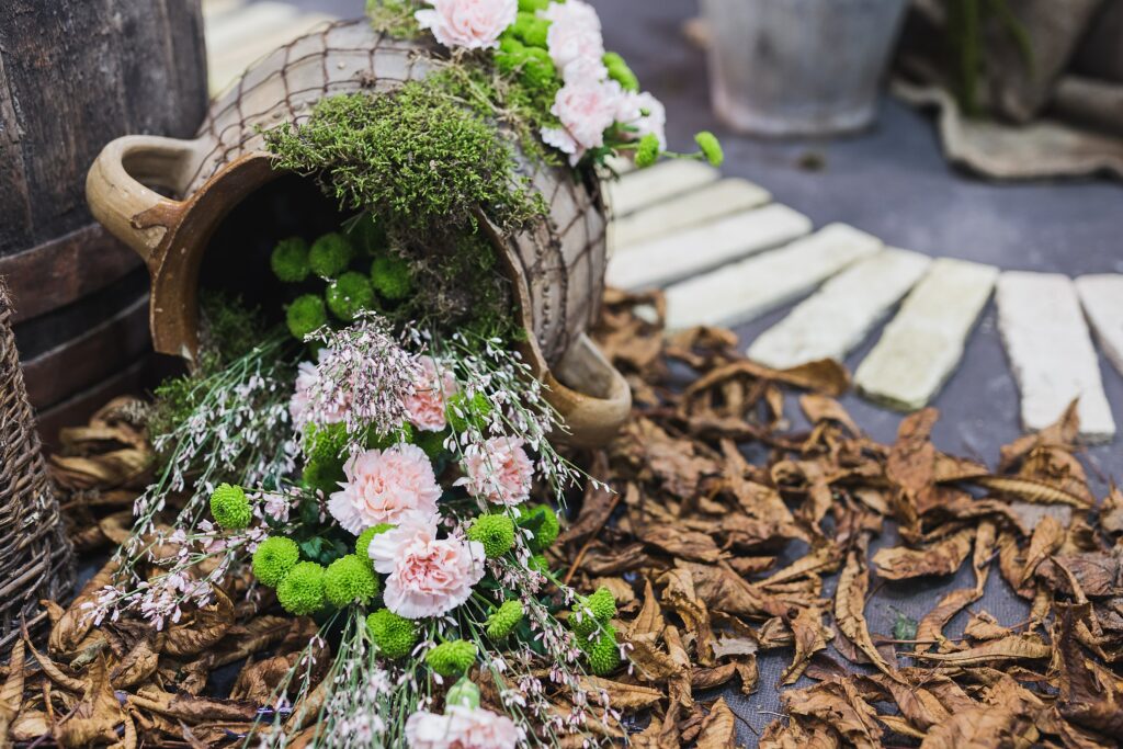 Rustic Jug with Vibrant Flowers: Autumnal Decor Wallpaper