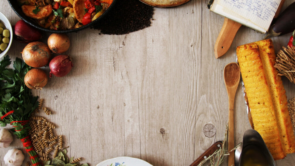 Cozy Rustic Wallpaper: Wooden Table with Fresh Veggies & Skillet Dish