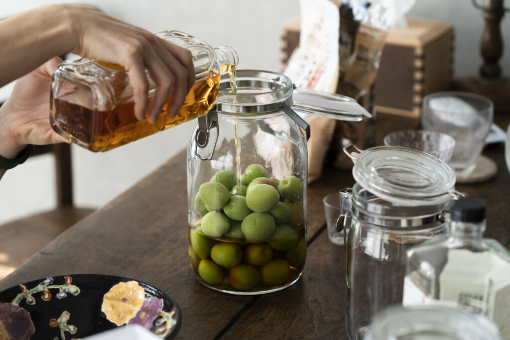 Charming Rustic Kitchen: Green Olives in Glass Jar & Golden Oil Pour Wallpaper