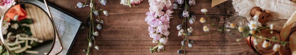 Elegant widescreen still life wallpaper with lavender larkspur vintage mirror and antique spools