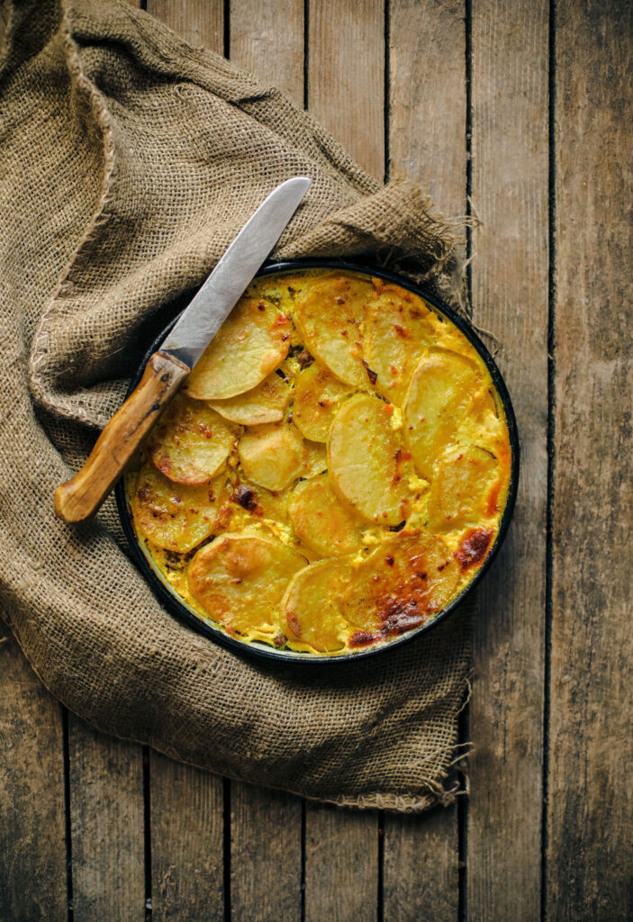 Rustic Moussaka with Golden Potatoes on Burlap - Wallpaper Background