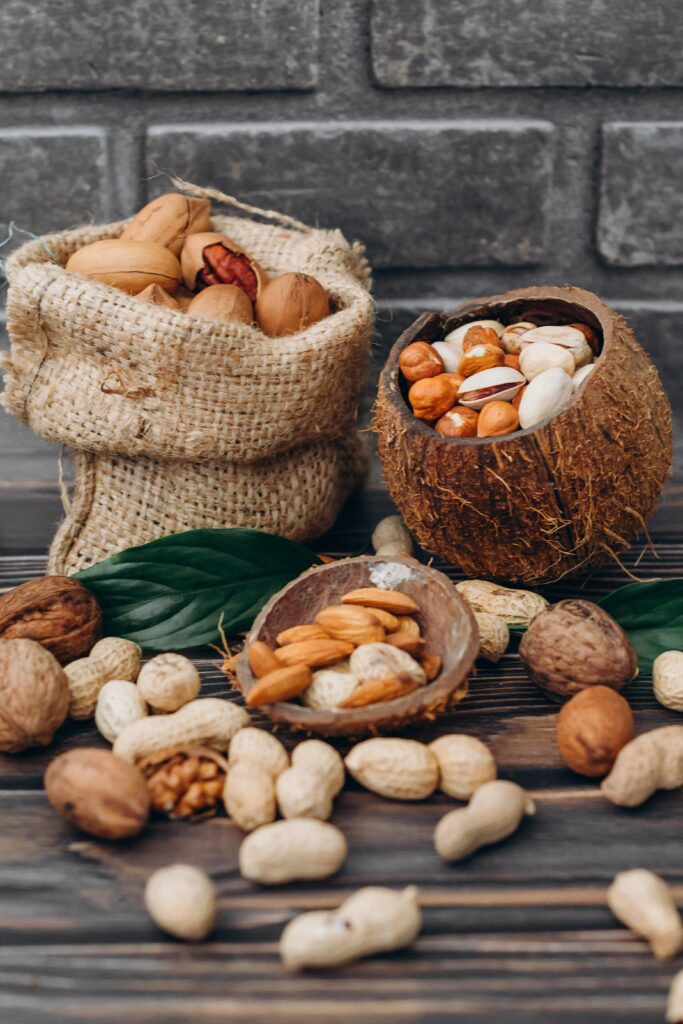 Rustic Nut Arrangement: Hazelnuts, Walnuts & Peanuts on Wood Background Wallpaper