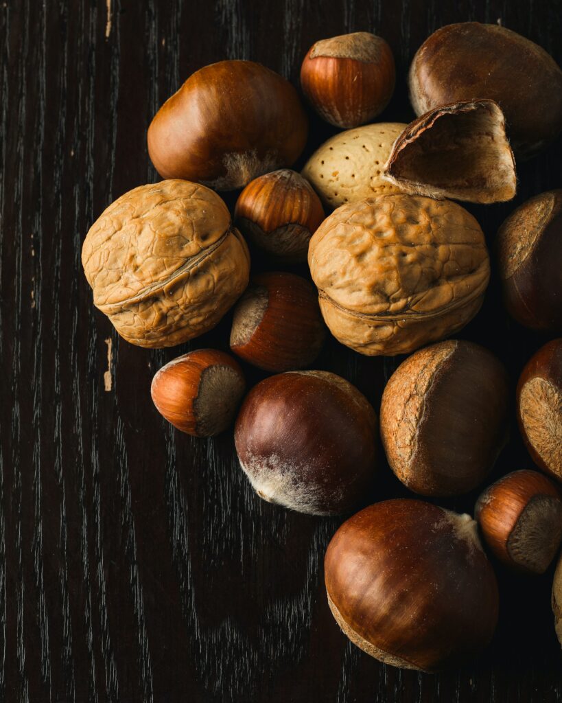 Rustic Nut Wallpaper: Hazelnuts & Walnuts on Dark Wood Background