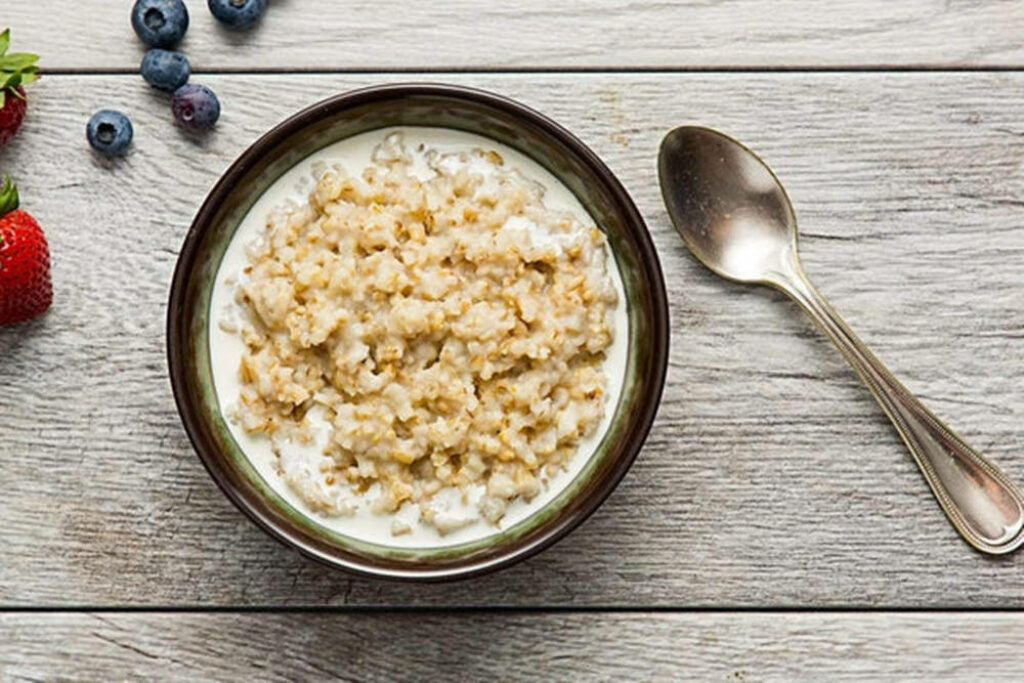 Rustic Oatmeal Bowl Flat Lay with Fresh Berries on Wood Background Wallpaper
