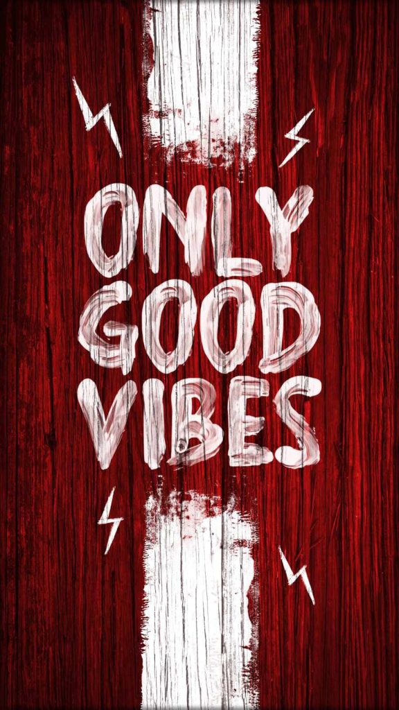 Rustic only good vibes wallpaper with white brush lettering lightning bolts on red wood grain