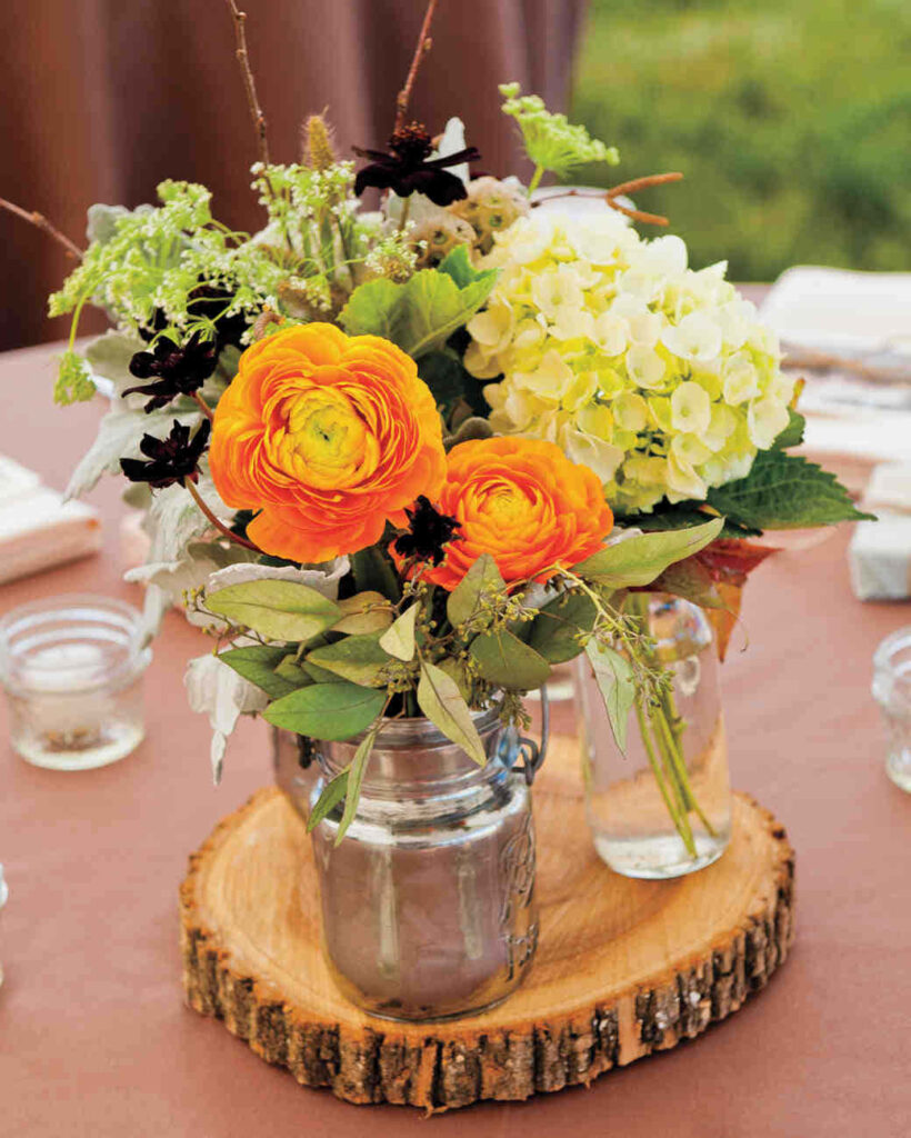 Rustic centerpiece wallpaper with orange ranunculus yellow hydrangeas dark blooms in mason jars