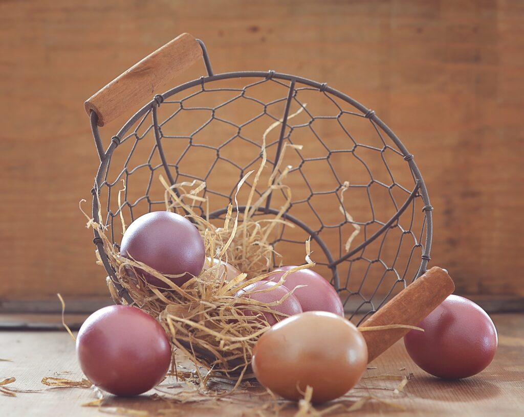 Cozy Pastel Easter Eggs Wallpaper Against Rustic Wooden Background