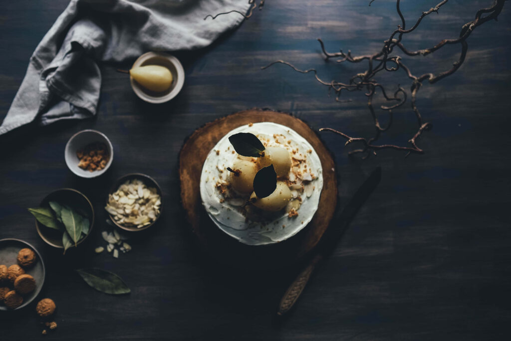 Rustic Pear Dessert Table: Dark Ambiance with Nuts & Natural Elements Wallpaper