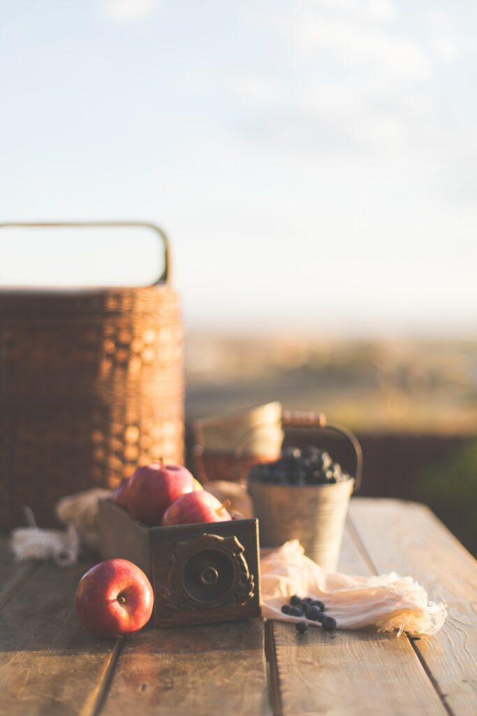 Rustic Picnic: Fresh Apples & Blueberries on Wooden Table Wallpaper