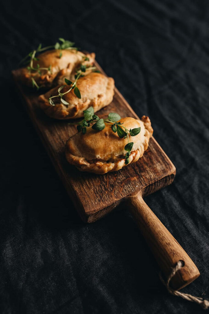 Rustic Pierogies Display: Golden Deep-Fried Delights on Wooden Board Wallpaper
