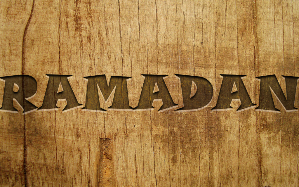 Rustic Ramadan wallpaper with bold cut-out font on warm natural wooden textured background