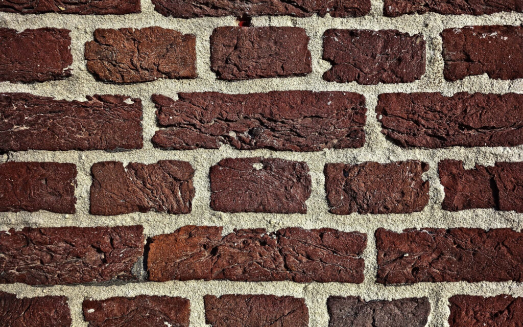 Vintage Brick Wall Close-Up: Rustic Red Texture Wallpaper Background