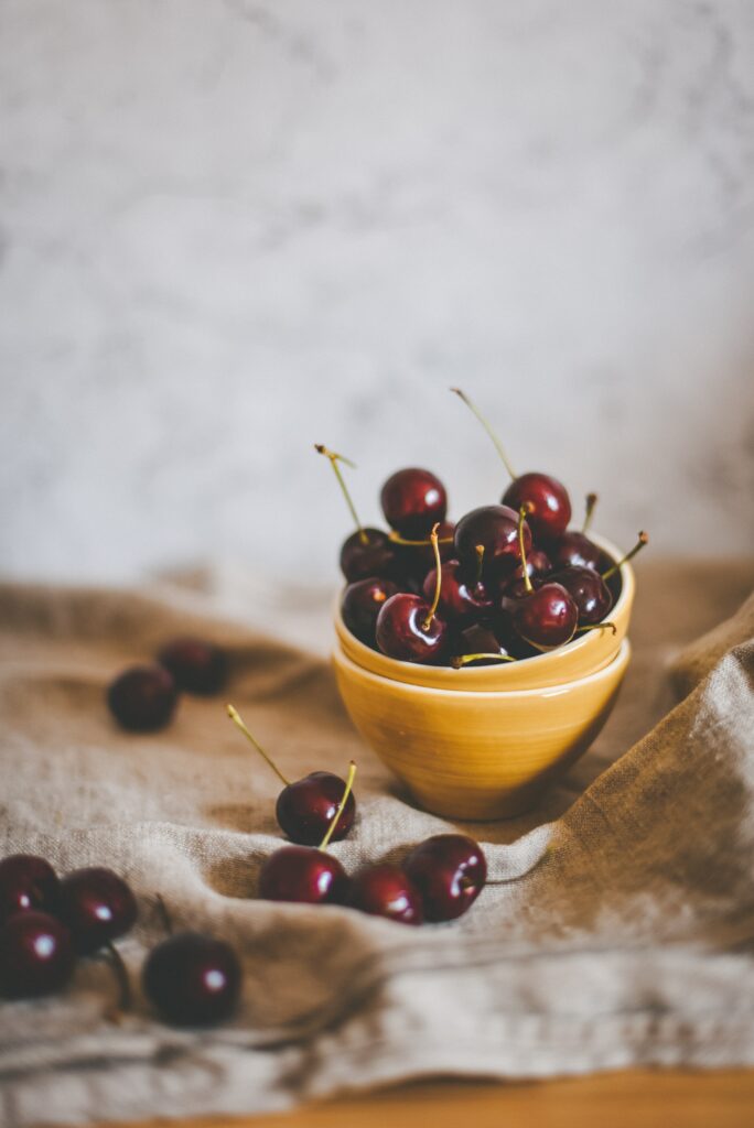 Rustic Ripe Cherries in Yellow Dish - Fresh Aesthetic Wallpaper