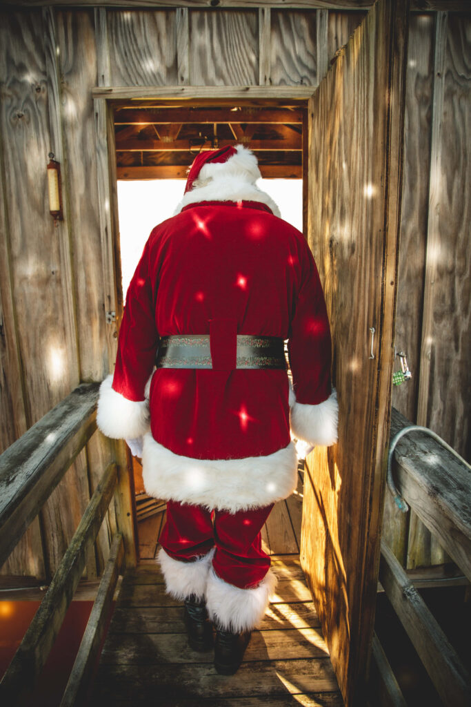 Rustic Santa Claus Wallpaper: Warm Festive Back-Angle Shot