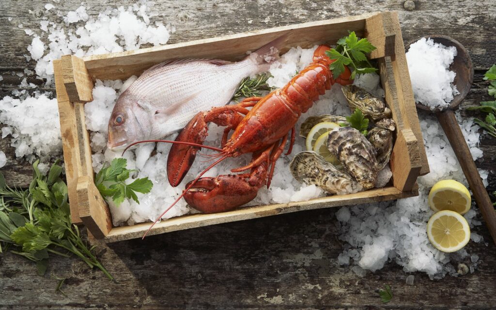Rustic Seafood Feast: Lobster, Fish, Mussels on Ice Wallpaper