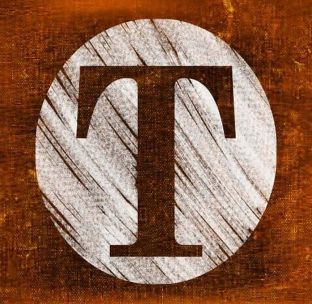 Bold serif letter T in white wood circle on dark brown rustic canvas wallpaper background