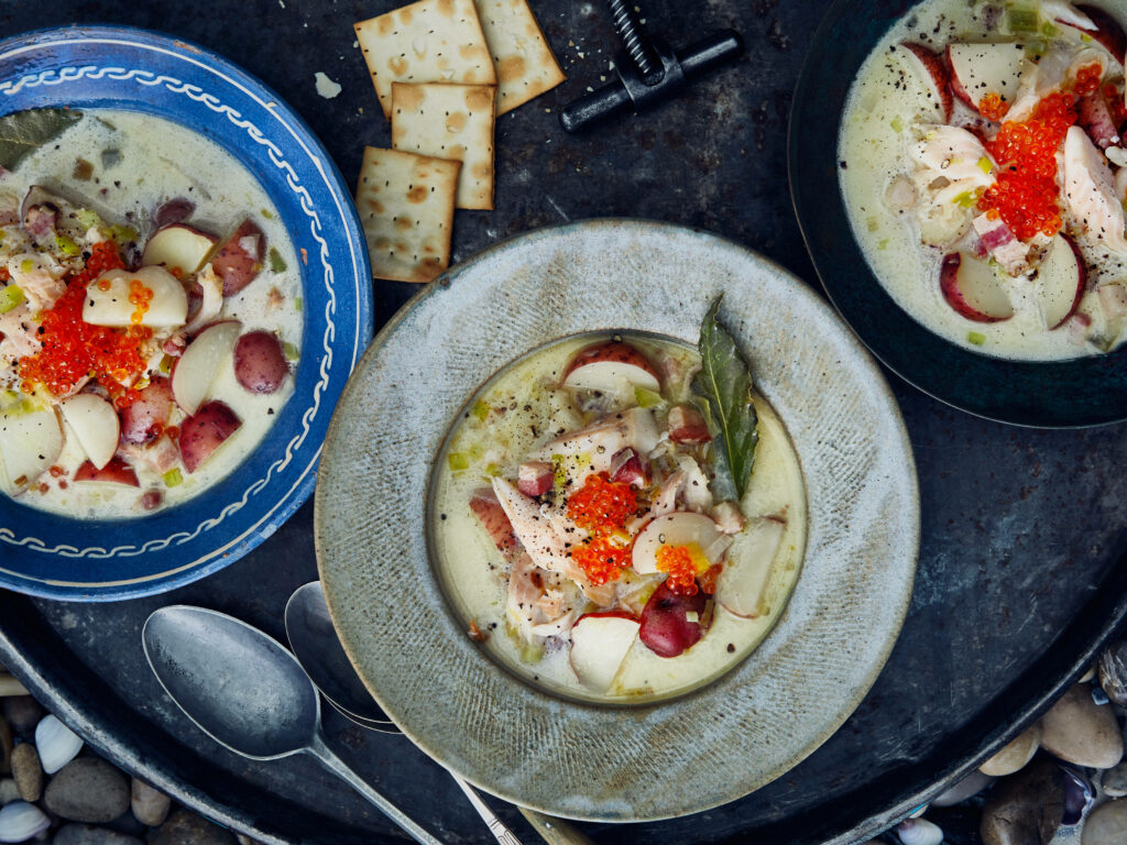 Rustic smoked fish chowder with creamy broth red potatoes herbs and vibrant fish roe in vintage bowls Wallpaper