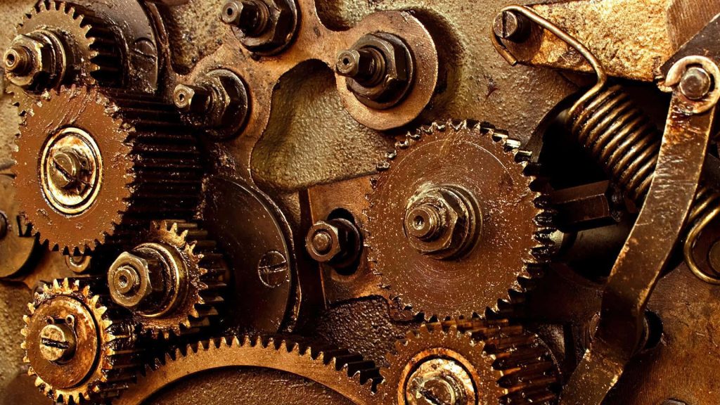 Rustic steampunk mechanical gears wallpaper macro shot with metal cogs bolts and tension spring
