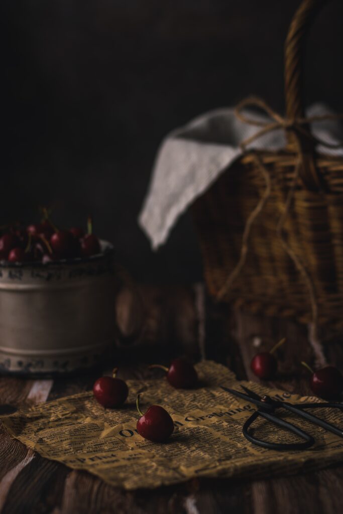 Rustic Still Life: Cherries and Scissors on Vintage Paper Wallpaper