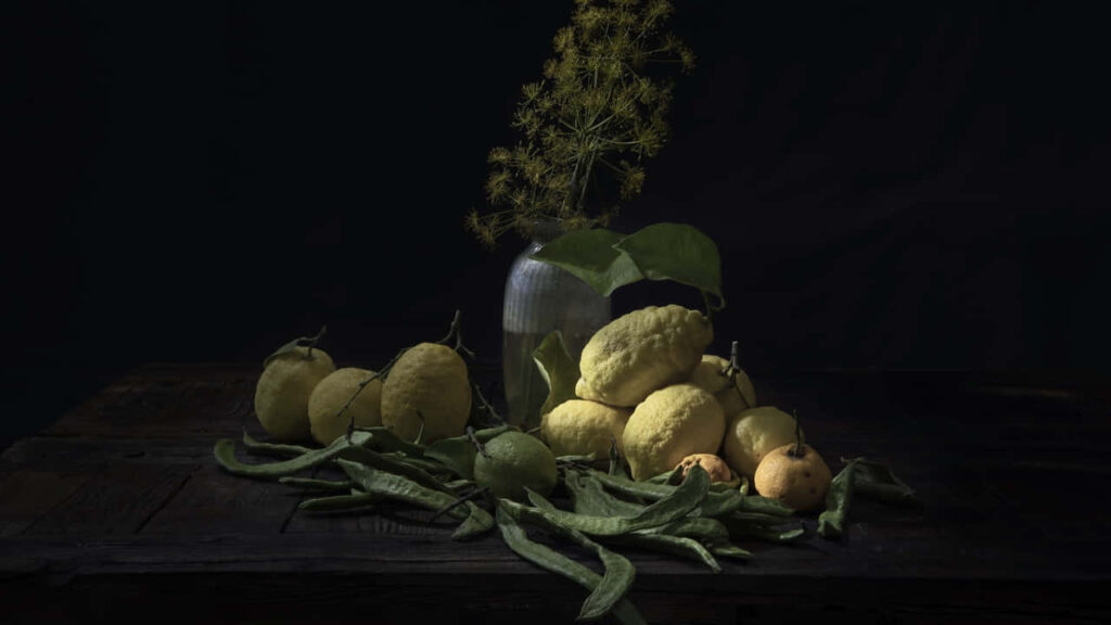 Rustic Still Life: Fresh Lemons & Greens on Dark Background Wallpaper
