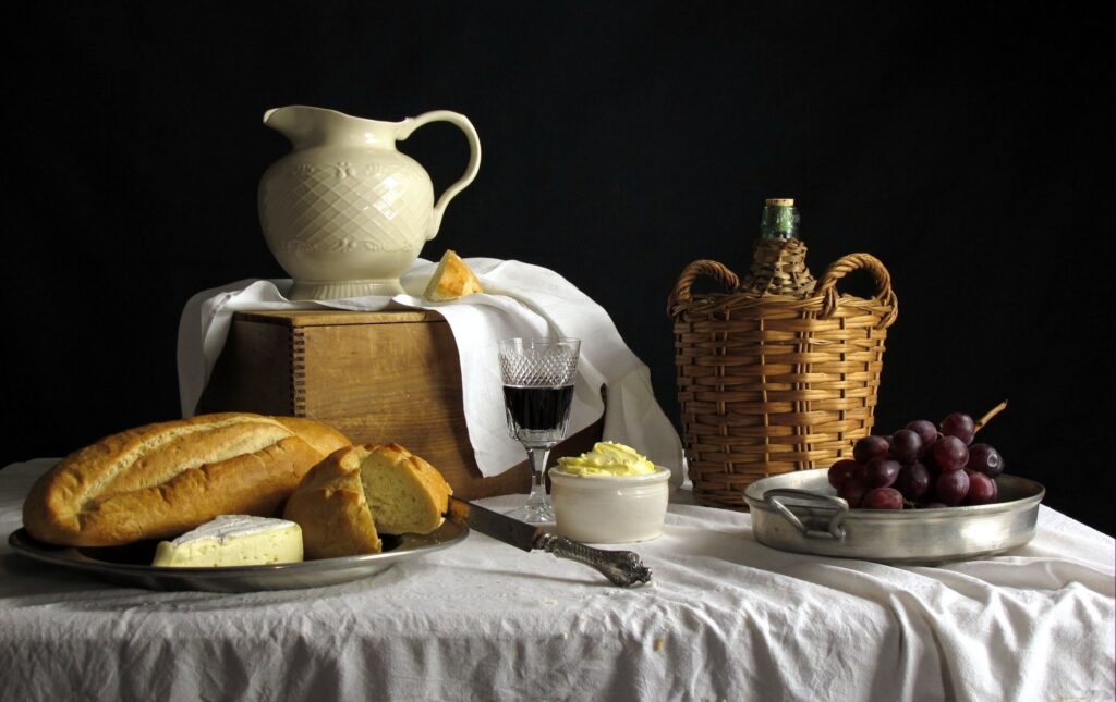 Rustic Still Life Wallpaper: Bread & Grapes on Dark Backdrop