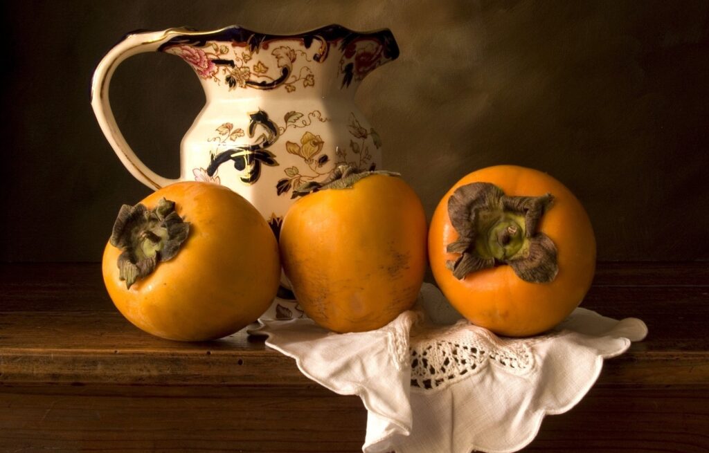 Rustic Still Life Wallpaper: Decorative Decanter & Ripe Persimmons