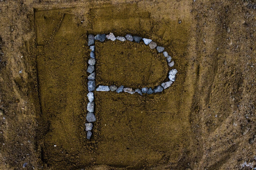 Stone Letter P Wallpaper on Sandy Background - Rustic Design