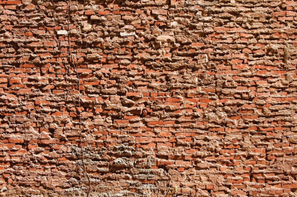 Rustic Textured Red Brick Wall Wallpaper Background - Weathered Look