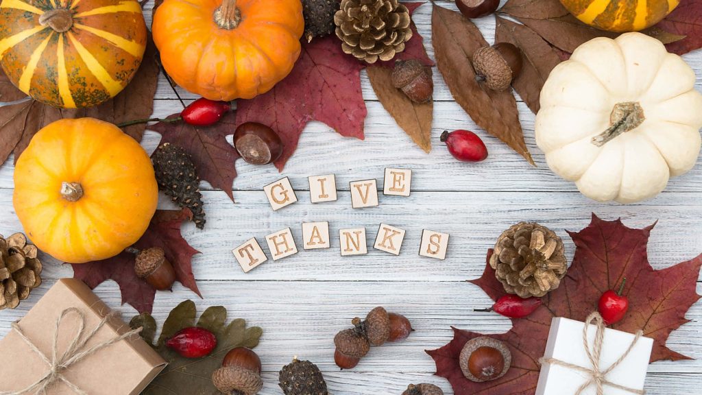 Rustic Thanksgiving wallpaper with wooden GIVE THANKS tiles autumn pumpkins leaves pinecones gift boxes