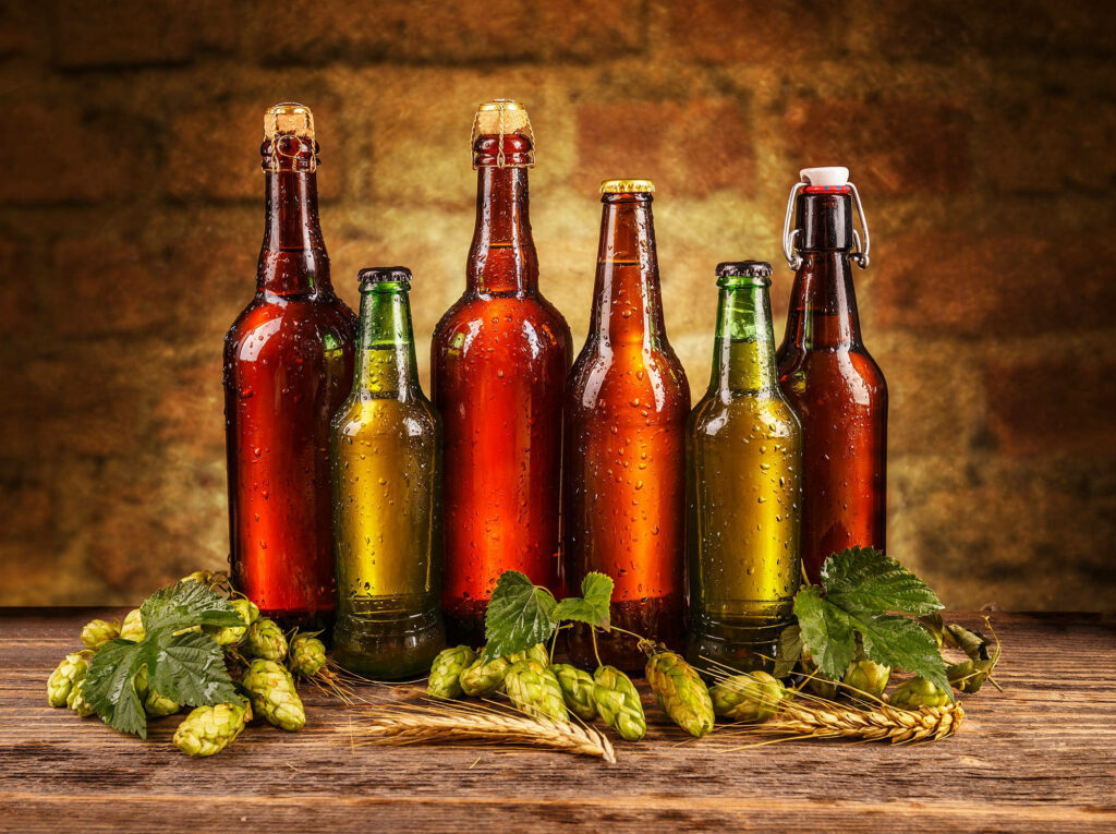 Rustic Beer Bottles & Hops Wallpaper: Cozy Brick Wall Background