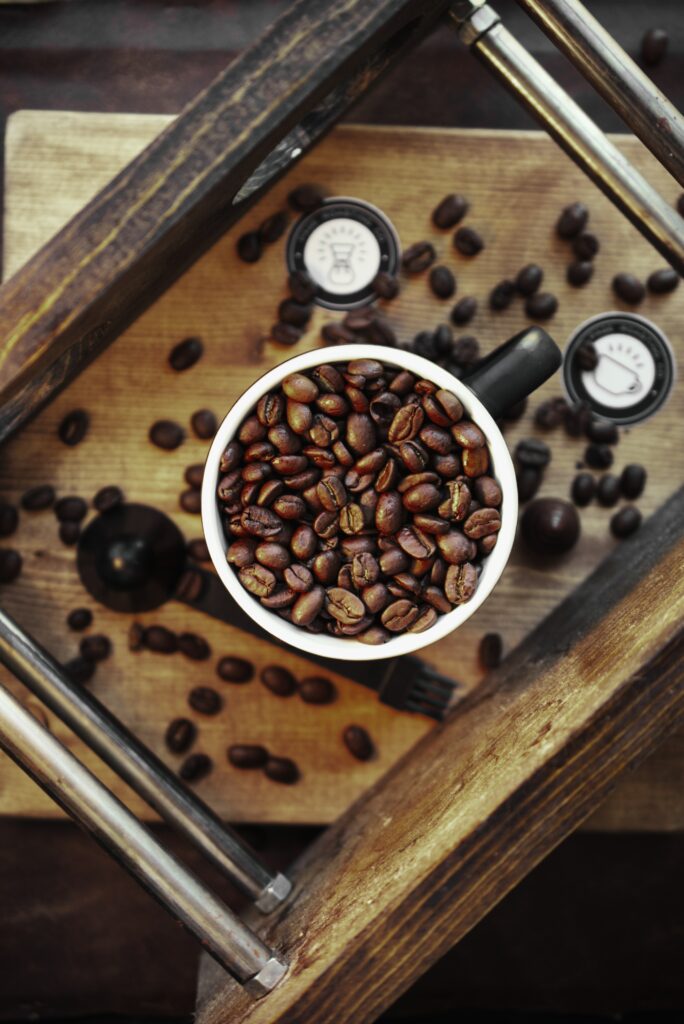 Rustic Coffee Cup Wallpaper with Roasted Beans on Wooden Surface