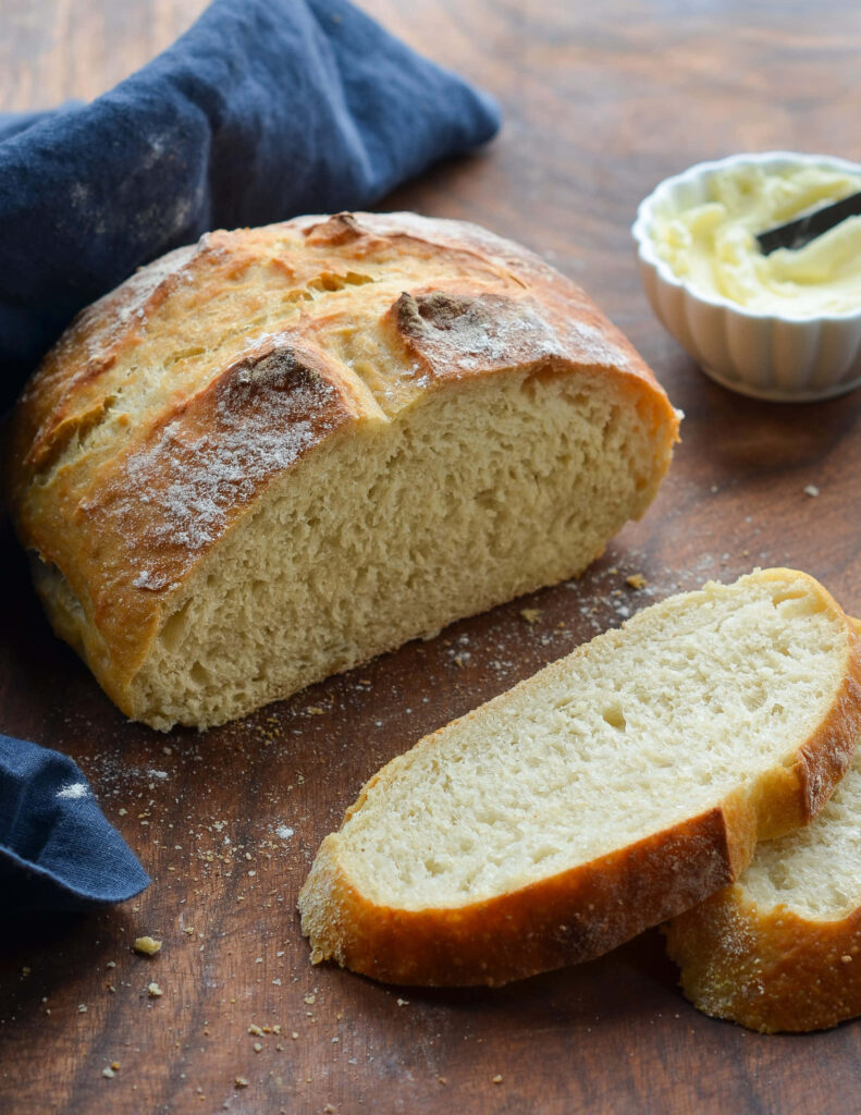 Rustic Wallpaper of Crusty Bread and Buttery Spread on Wood