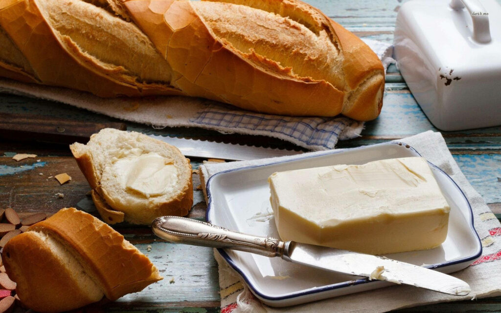 Warm Rustic Wallpaper: Freshly Sliced Bread & Butter on Wood
