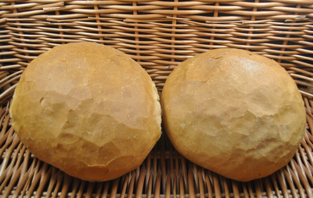 Rustic Wallpaper: Crusty Round Bread Loaves on Wicker Background