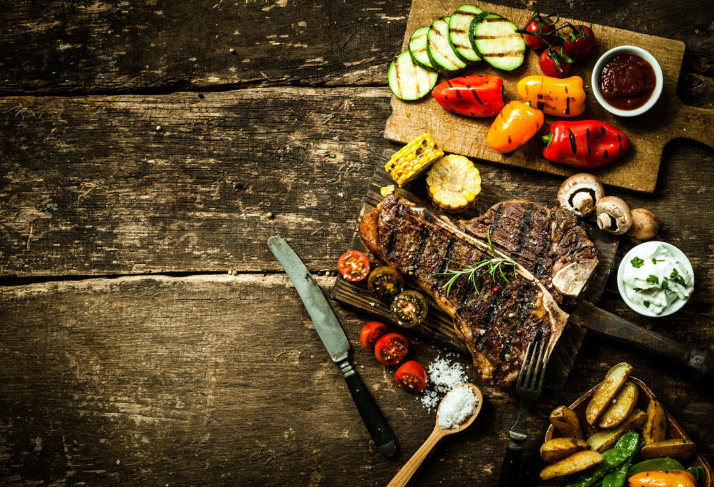 Rustic Wallpaper: Grilled Steak & Vegetables on a Wooden Table